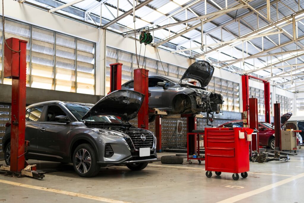 Vehicles on lifts at automotive repair shop